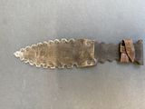 a knife that is laying on a table next to a knife