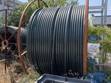 a large black hose that is next to a trash can