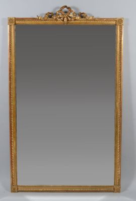 an antique gold framed mirror with a decorative design