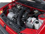 a red car with its hood open and the engine in the trunk