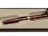 brown wooden pen in a box on a white surface