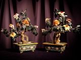 two bonsais that are sitting on a table
