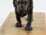 statue of a lion on a marble block on a white background