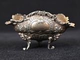 an antique silverware bowl with a decorative design on a black background