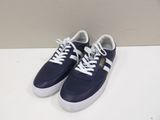 a pair of blue and white sneakers on a white surface