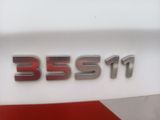 a close up of a badge on a white car
