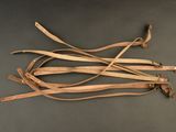 three pieces of leather are tied together on a black surface
