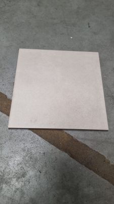 a piece of paper on the floor next to a piece of tape