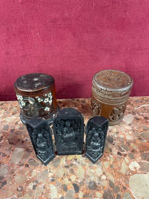 three vases sitting on a table with a red wall in the background