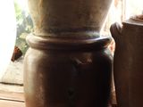 two vases sitting on a window sill next to a window