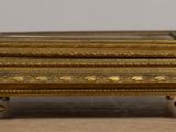 a small gold box on a table on a table