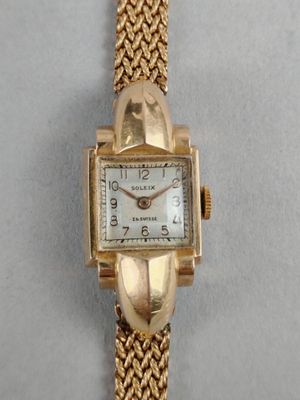 an image of a ladies ' s watch with a gold bracelet