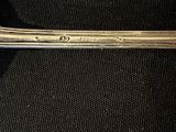 a spoon with a handle on a black surface