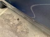 a car that has been painted blue and is parked on the side of the road