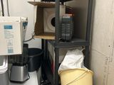 a stack of boxes on top of a shelf next to a toilet