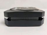 a close up of a black plastic object on a white surface