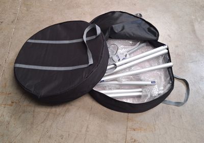 a black bag with a set of sticks in it on the floor