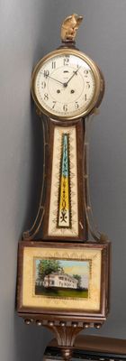 a clock that is sitting on a shelf next to a wall