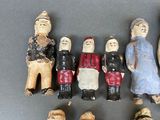 many figurines of people standing together on a table