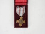 an image of a medal in a red case on a white surface