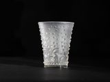 a glass cup that is sitting on a table