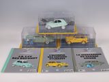 four toy cars in a display case on a table