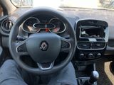 a man sitting in the driver ' s seat of a car