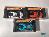 three toy cars that are in a box on a table