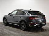 the rear end of a gray audi qx parked in a garage