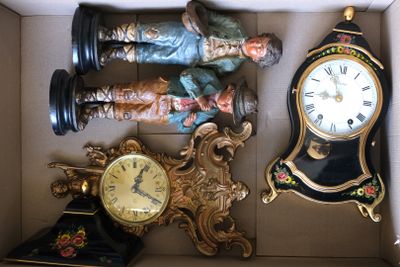 une boîte contenant une horloge et une figurine