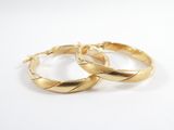 two gold hoop earrings on a white background