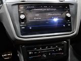 a car dashboard with a radio and a steering wheel