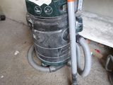 a vacuum that is sitting on the floor next to a shelf