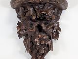 an image of a wooden carving of a man with a hat on his head
