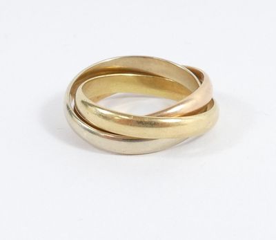 two gold rings are stacked on top of each other on a white surface