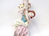 a figurine of a woman holding a vase