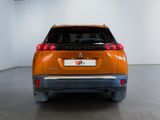 the rear end of an orange suv parked in a white room
