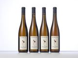 three bottles of wine sitting on top of a table next to each other