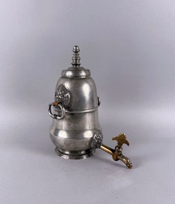 an antique silver coffee pot with a brass handle and a bird on it