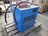 a blue machine that is sitting on a pallet