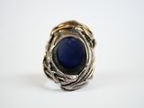 a close up of a ring with a blue stone in it