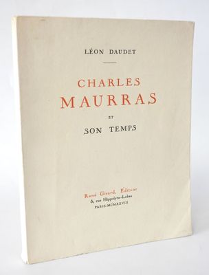 a white book with orange writing on it sitting on a table