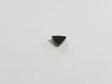 a black triangle shaped stone on a white surface