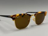 a close up of a pair of sunglasses on a white surface