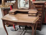 a wooden desk with a mirror on top of it