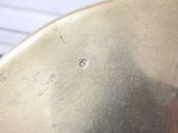 a metal bowl with a hole in it on a table