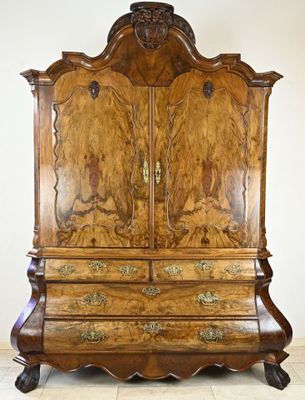 an image of a large wooden cabinet with carvings on the doors