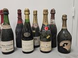 several bottles of wine are lined up on a table