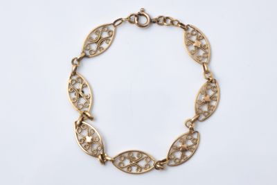 a gold plated bracelet with an intricate design