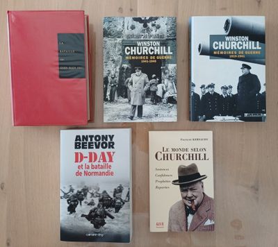 several books on a wooden table with a red cover